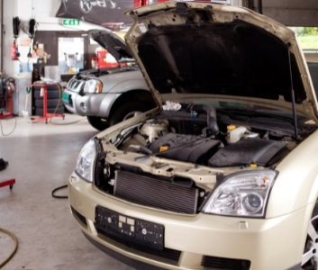 two cars in automobile repair and servicing workshop